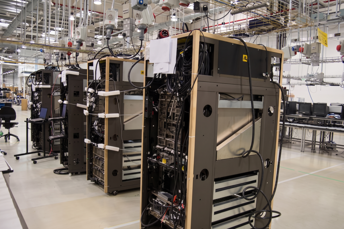 A clean, enterprise-grade server rack and a digital interface displaying a security monitoring dashboard, demonstrating a proactive business defense against manufacturing cybersecurity risks.
