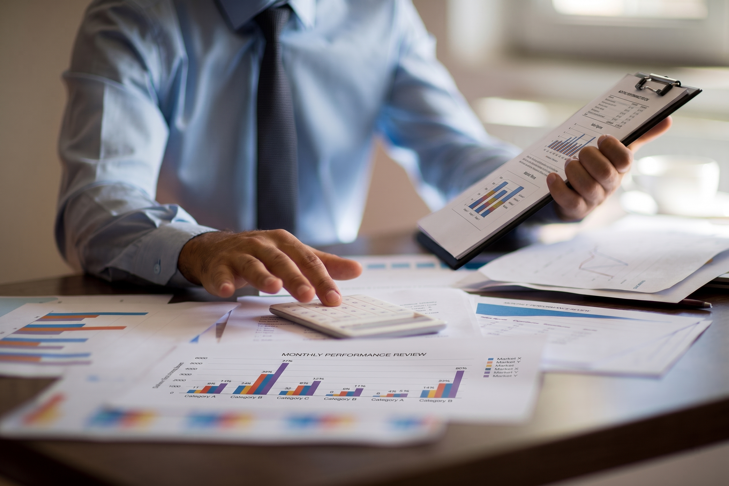 Business professional calculating the total cost of in-house IT spending