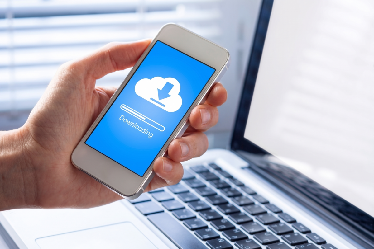 A smartphone downloading cloud files, illustrating insider data theft risks during employee offboarding.