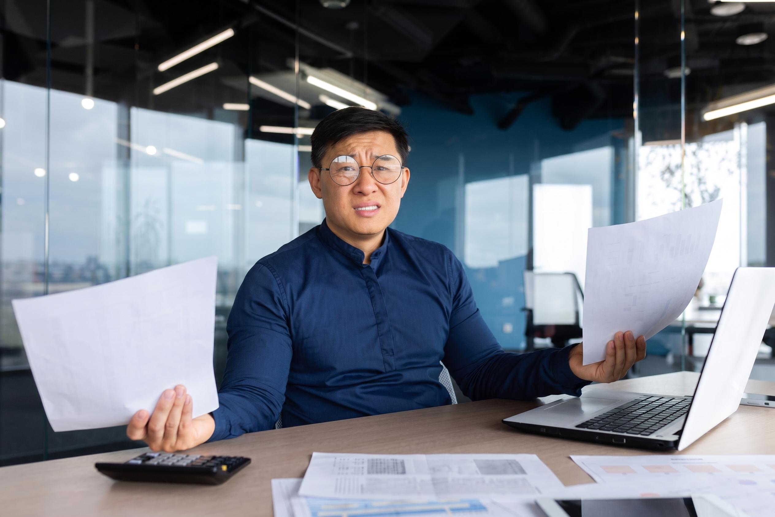 Business professional reviewing documents after the departure of an IT employee